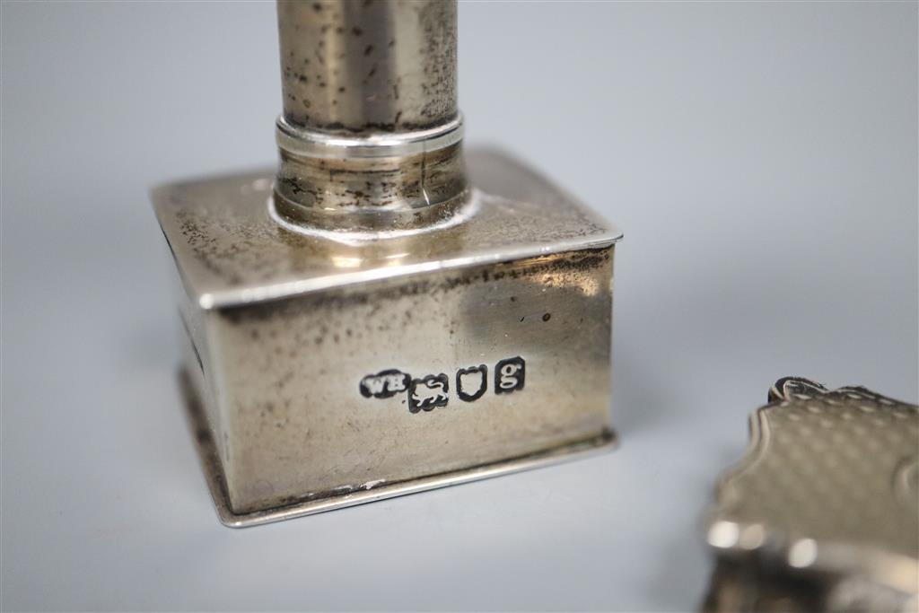 An Edwardian silver stamp press?, William Hornby, London 1902, retailed by Asprey, London, 8cm and a Victorian solver vinaigrette.
